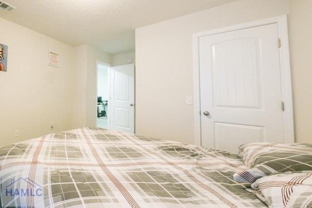 unfurnished bedroom with a textured ceiling and a closet