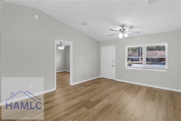 unfurnished room featuring lofted ceiling, hardwood / wood-style flooring, and ceiling fan