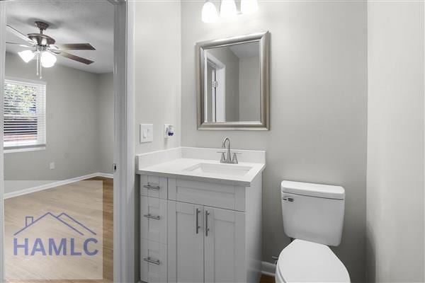 bathroom with ceiling fan, toilet, and vanity