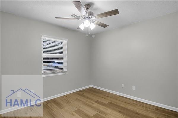 empty room with hardwood / wood-style floors and ceiling fan