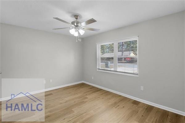 unfurnished room featuring hardwood / wood-style floors and ceiling fan