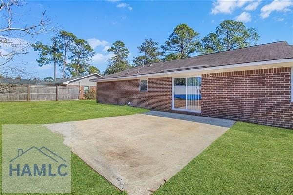 back of house featuring a patio and a yard