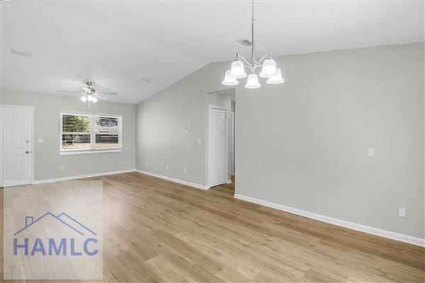 interior space with ceiling fan with notable chandelier, light hardwood / wood-style flooring, and lofted ceiling