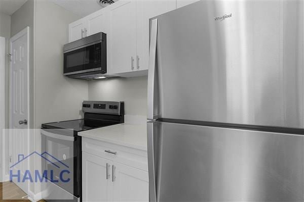 kitchen featuring white cabinetry and stainless steel appliances