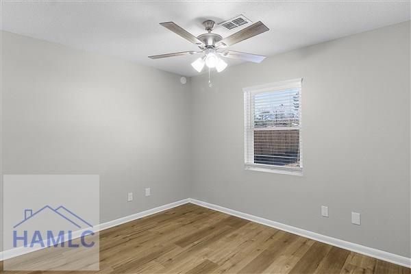 spare room featuring ceiling fan and hardwood / wood-style floors