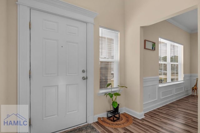 entrance foyer featuring crown molding and wood-type flooring