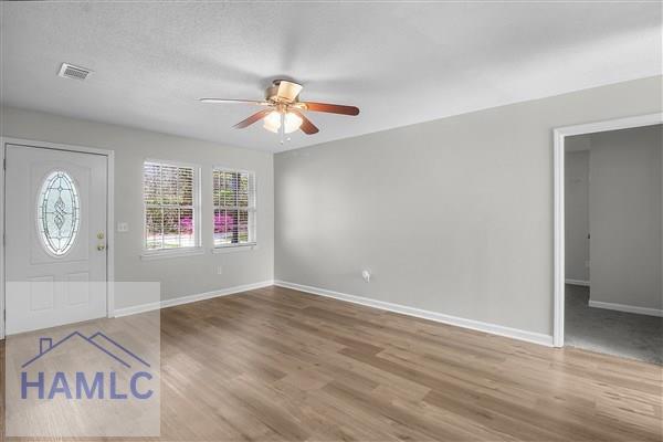 1110 Ricade Dr, Hinesville, GA 31313 - entrance foyer with visible vents, baseboards, a ceiling fan, and wood finished floors