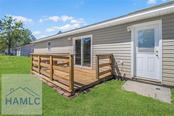 1110 Ricade Dr, Hinesville, GA 31313 - wooden deck with fence and a lawn