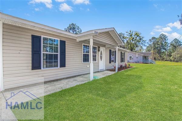 1110 Ricade Dr, Hinesville, GA 31313 - view of property exterior with a yard