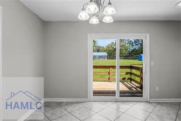1110 Ricade Dr, Hinesville, GA 31313 - entryway featuring light tile patterned floors, baseboards, and a notable chandelier