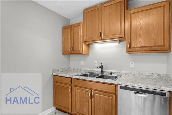 1110 Ricade Dr, Hinesville, GA 31313 - kitchen featuring brown cabinetry, dishwasher, and a sink