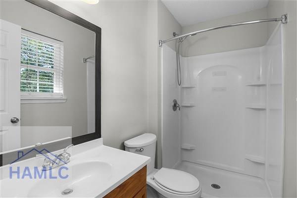 1110 Ricade Dr, Hinesville, GA 31313 - full bathroom with vanity, walk in shower, and toilet