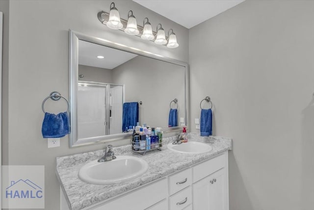 bathroom with an enclosed shower and vanity