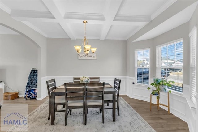 dining area with an inviting chandelier, ornamental molding, wood-type flooring, coffered ceiling, and beam ceiling