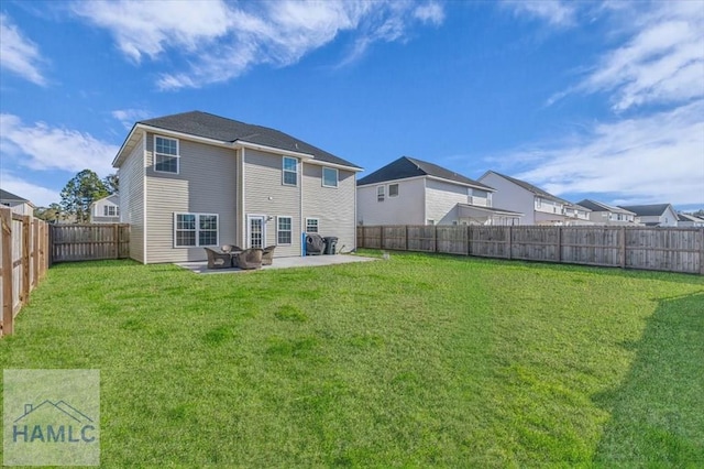 rear view of house with a yard and a patio area