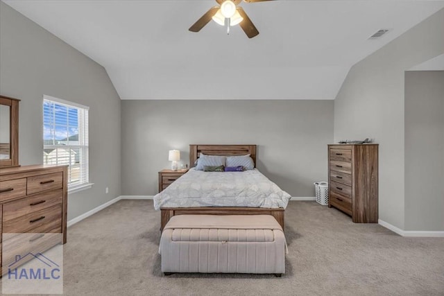 bedroom featuring ceiling fan, vaulted ceiling, and light colored carpet