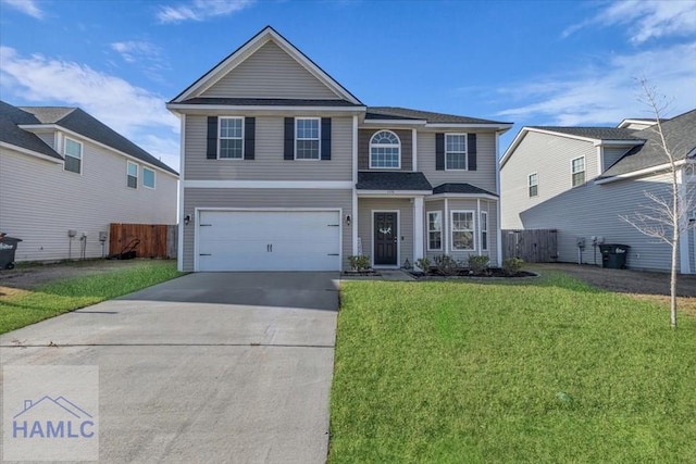 view of property featuring a front yard and a garage