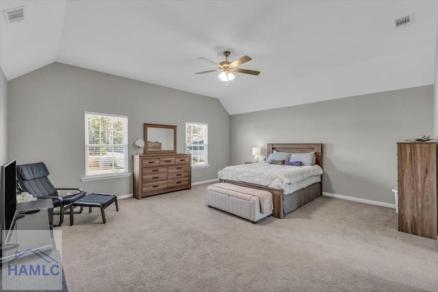 bedroom with lofted ceiling, light colored carpet, ceiling fan, and multiple windows