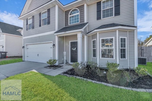 view of front property with a garage, cooling unit, and a front lawn