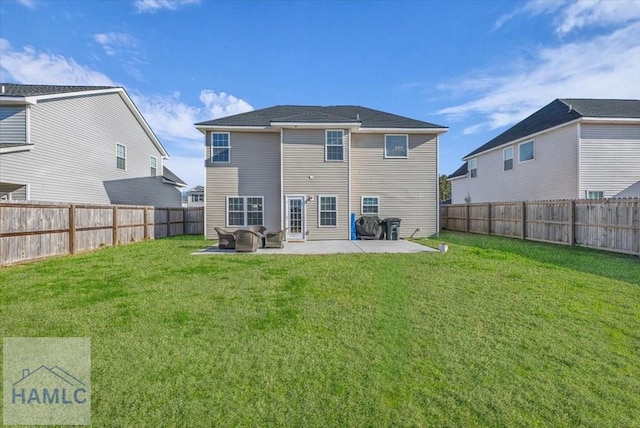 rear view of house with a patio and a lawn