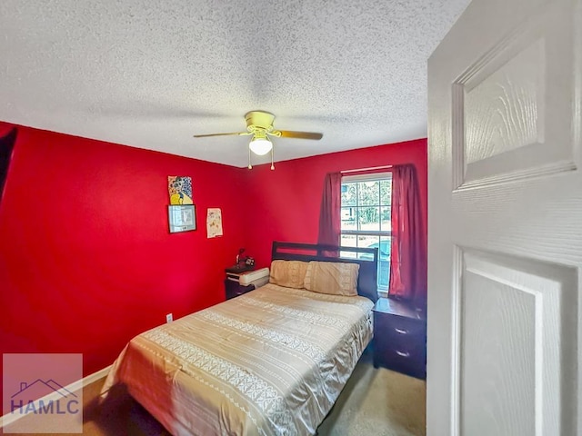 bedroom with ceiling fan and a textured ceiling