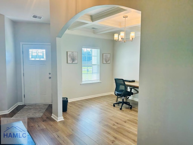 173 Akins Ranch Rd NE, Ludowici, GA 31316 - entryway with arched walkways, plenty of natural light, coffered ceiling, ornamental molding, and wood finished floors