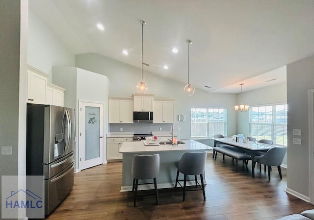 173 Akins Ranch Rd NE, Ludowici, GA 31316 - kitchen featuring appliances with stainless steel finishes, an island with sink, dark wood-style floors, white cabinetry, and high vaulted ceiling