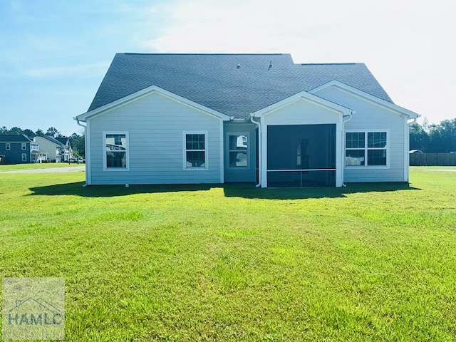 173 Akins Ranch Rd NE, Ludowici, GA 31316 - back of house featuring a yard, roof with shingles, and a sunroom