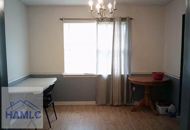 1013 Barley Dr, Hinesville, GA 31313 - dining area with baseboards, a wealth of natural light, a chandelier, and wood finished floors