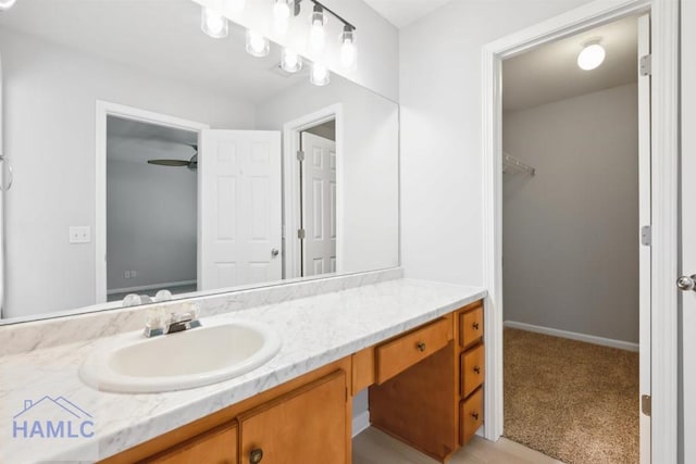 24 Stalwick Dr, Pooler, GA 31322 - bathroom with vanity, a walk in closet, and baseboards
