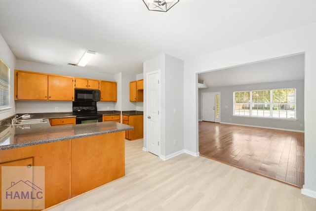 24 Stalwick Dr, Pooler, GA 31322 - kitchen with black appliances, light wood finished floors, a sink, and dark countertops