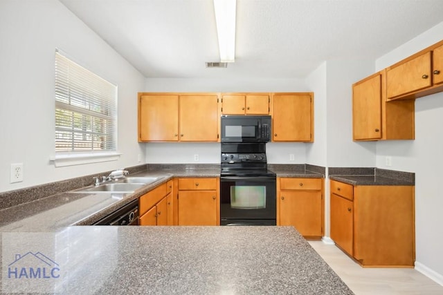 24 Stalwick Dr, Pooler, GA 31322 - kitchen with black appliances, a sink, dark countertops, and light wood finished floors