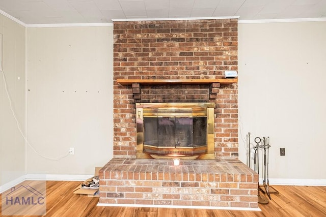 interior details featuring ornamental molding, a brick fireplace, and wood-type flooring