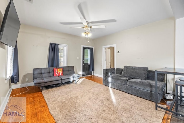 living room featuring hardwood / wood-style flooring and ceiling fan