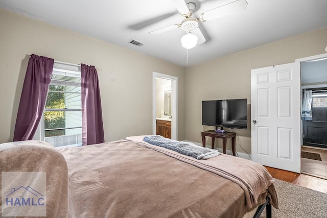 bedroom featuring ensuite bathroom, ceiling fan, and wood-type flooring