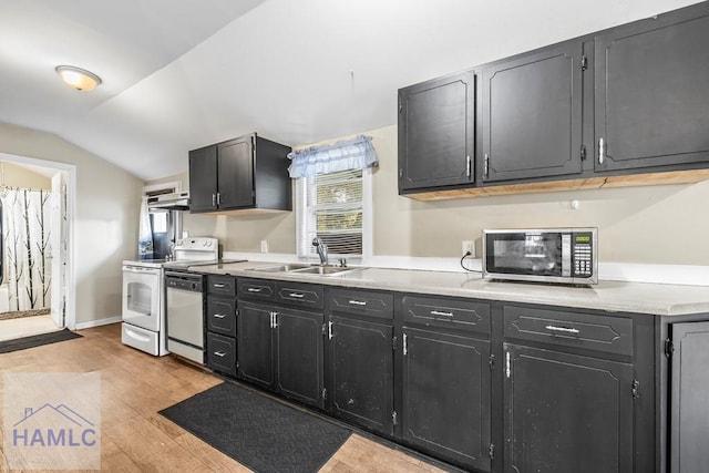 kitchen featuring light hardwood / wood-style flooring, sink, stainless steel appliances, and lofted ceiling