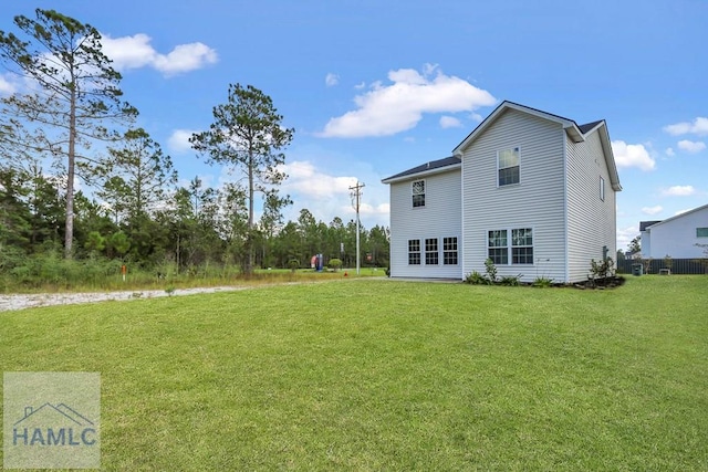 rear view of property with a yard