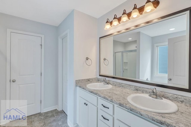 bathroom with tile patterned floors, vanity, and a shower with door