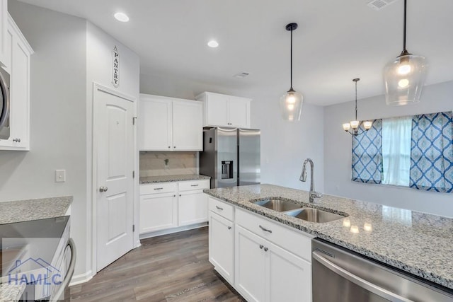 kitchen with white cabinetry, sink, pendant lighting, and appliances with stainless steel finishes