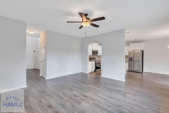 unfurnished living room with ceiling fan and light hardwood / wood-style floors