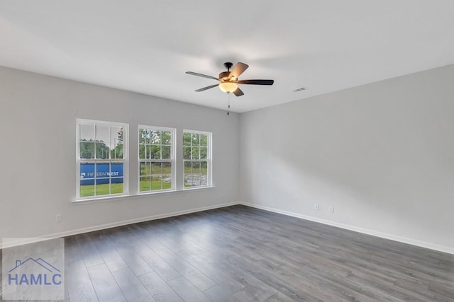 empty room featuring ceiling fan and dark wood-type flooring