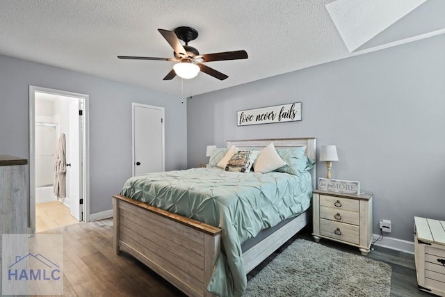 226 Topi Trl, Hinesville, GA 31313 - bedroom with wood finished floors, a textured ceiling, baseboards, ceiling fan, and ensuite bath