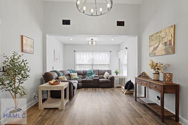 226 Topi Trl, Hinesville, GA 31313 - living room featuring a high ceiling, wood finished floors, a chandelier, and baseboards