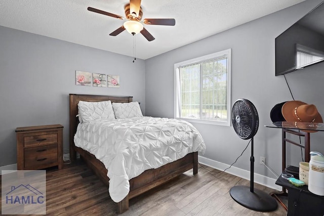 226 Topi Trl, Hinesville, GA 31313 - bedroom featuring wood finished floors, baseboards, a textured ceiling, and ceiling fan