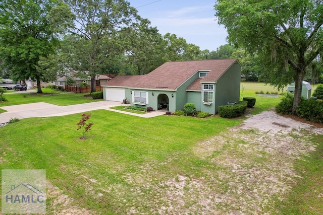 226 Topi Trl, Hinesville, GA 31313 - view of front of house with concrete driveway, a front yard, a garage, and stucco siding
