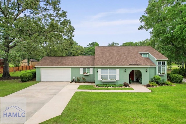 226 Topi Trl, Hinesville, GA 31313 - view of front of property featuring stucco siding, an attached garage, driveway, and roof with shingles