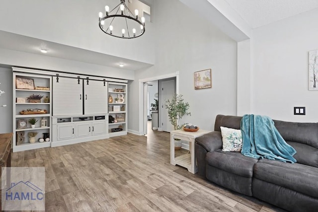 226 Topi Trl, Hinesville, GA 31313 - living area featuring a chandelier, light wood-style floors, and baseboards