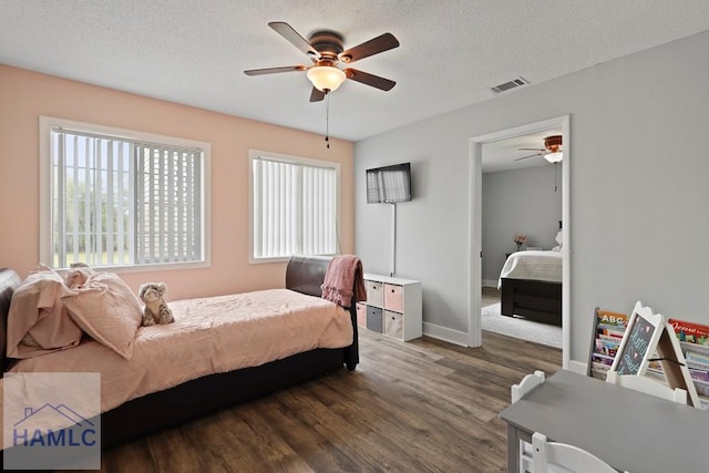226 Topi Trl, Hinesville, GA 31313 - bedroom featuring wood finished floors, a textured ceiling, ceiling fan, and baseboards