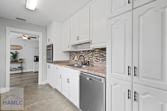 226 Topi Trl, Hinesville, GA 31313 - kitchen with stainless steel appliances, a sink, ceiling fan, white cabinetry, and backsplash