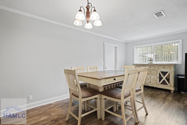 226 Topi Trl, Hinesville, GA 31313 - dining space featuring a chandelier, crown molding, wood finished floors, baseboards, and a textured ceiling